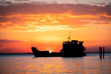 Fraser Island Ferry at sunset with orange sky, Fraser Island, Queensland, Australia