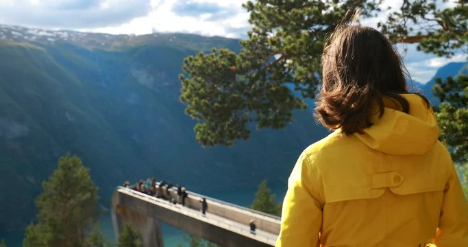 Norway. Young Adult Caucasian Woman Lady Tourist Traveler Photographer Walking Near Stegastein Viewpoint In Sogn And Fjordane Fjord. Norwegian Landmark And Popular Destination