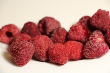 red raspberries on a white background