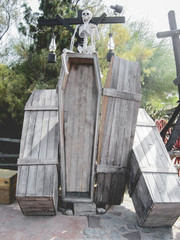 Open grave next to a skeleton as Halloween decoration