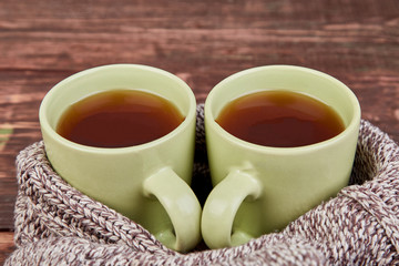 Two warm cups of tea, autumn leaves on wooden table. Autumn. Fall season. Still life. Flat lay. Top view.