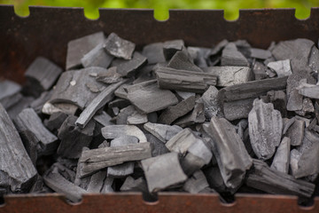 Black coals for a barbecue. Charcoal bonfire background