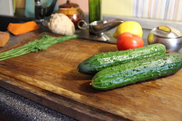 cucumbers and tomatoes on wooden board