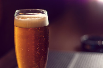 glass of beer close up on wooden table