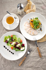 lunch set beetroot cheese salad and roasted turkey fillet with pumpkin and cup of green tea on the table