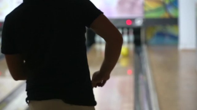 Bowling. Strike. Bowling strike, bowling ball knocks down bowling pins in slow motion. Man throwing ball for bowlings