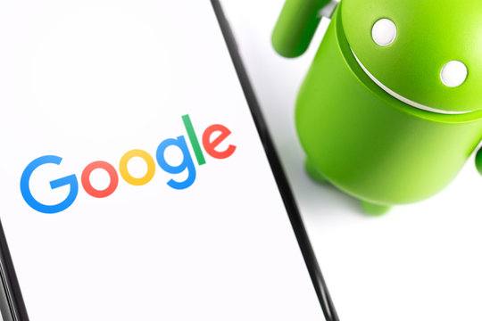 Google Android figure and smartphone. Google Android is the operating system for smartphones, tablet computers, e-books, game consoles, and other devices. Moscow, Russia - March 17, 2019
