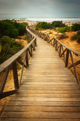 Wooden walkway to the sea on the beaches of Chiclana in Cadiz
