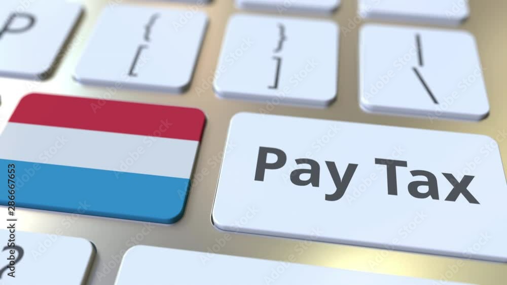Aufkleber pay tax text and flag of luxembourg on the buttons on the computer keyboard. taxation related concep