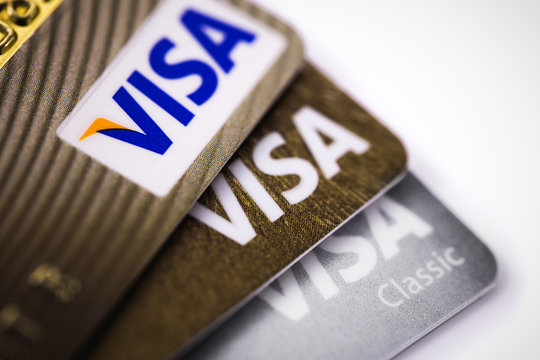 pile of Visa cards, credit cards on white background. business concept. Visa - American multinational company providing services of payment operations. Moscow, Russia - March 12, 2019