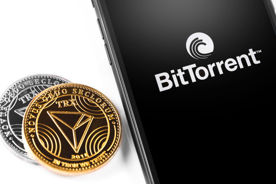 Tron TRX coins and smartphone with BitTorrentLIVE logo. Website of BitTorrent, a communication protocol for peer-to-peer file sharing (P2P). Moscow, Russia - March 26, 2019