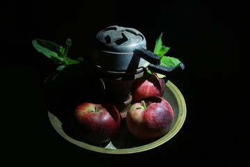 bowl with tobacco for hookah. berries on a black background