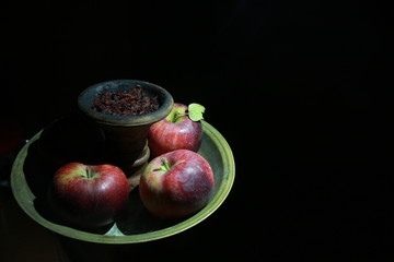 bowl with tobacco for hookah. berries on a black background