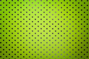 Light green background from metal foil paper with a silver stars pattern.