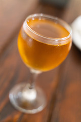 a glass of white wine on a wooden table with selective focus and soft background blur