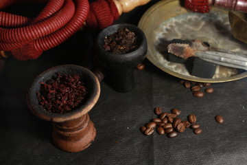 bowl with tobacco for hookah. berries on a black background