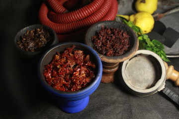 bowl with tobacco for hookah. berries on a black background