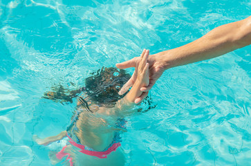 kid is drowning in the sea. Selective focus.