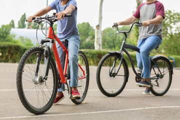 Fototapeta premium Happy father and son riding bicycles outdoors