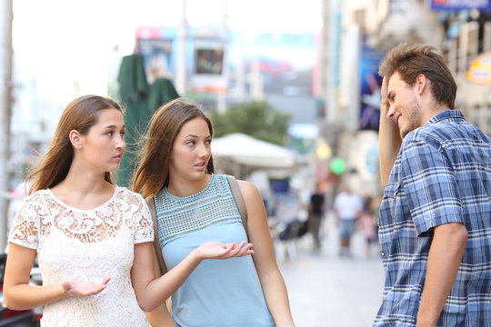 Man flirting with disappointed women in the street