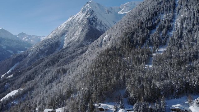 Winter season cinematic aerial shot with scenic mountains. Beautiful frozen panorama on a sunny morning
