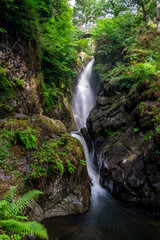 Aira Force waterfall Lake District, Northern England UK with stone bridge