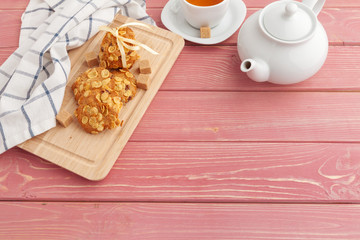 Homemade crunchy cookies and  tea on a wooden table