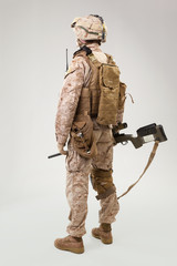 Studio shoot of modern infantry soldier, U.S. marine rifleman in combat uniform, helmet and body armor