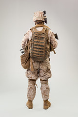 Portrait of a young American US Marine Corps soldier over grey background