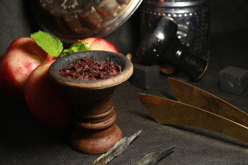 bowl with tobacco for hookah. berries on a black background