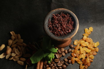 bowl with tobacco for hookah. fruits on a black background. smoke hookah