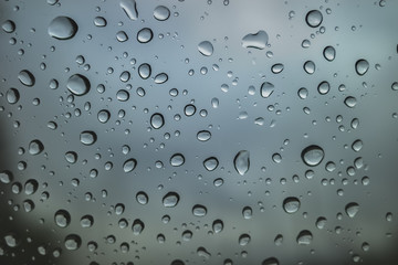 raindrops on the glass, on a gray background.