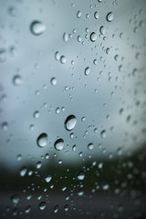 raindrops on the glass, on a gray background. Selective focus