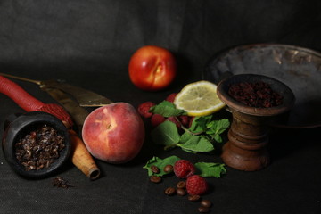 bowl with tobacco for hookah. berries on a black background