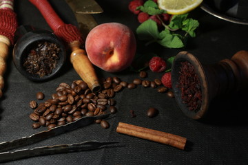 bowl with tobacco for hookah. berries on a black background