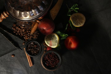 bowl with tobacco for hookah. fruits on a black background. smoking hookah