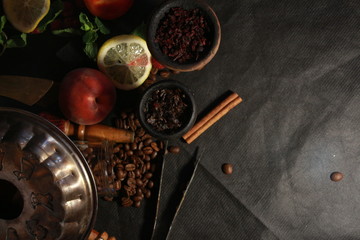 bowl with tobacco for hookah. fruits on a black background. smoke hookah