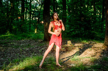 Perfect body in sexy costume. sexy girl in leather clothes. ethnic tribal fashion. deep forest....