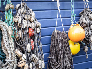 Fishing nets and ropes hang outside on the house wall