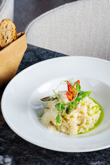 Close up view on tradtional and tasty risotto with parmesan, asparagus and chili. Mediterranean and italian cuisine. Soft, selective focus. Rise with asparagus. Copy space. Food photography