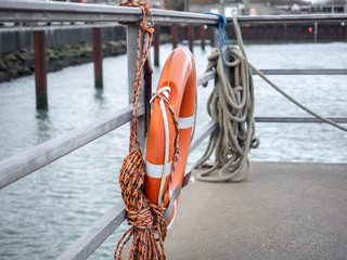 A lifebuoy hangs ready at the harbor