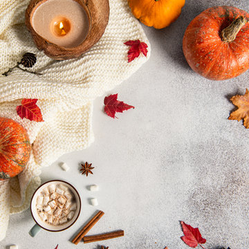 Fototapeta Hygge. Autumn Thanksgiving composition Background with copy space. Flat lay. Candle, pumpkins, autumn leaves, hot cocoa mug. Autumn mood