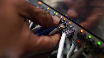 Computer engineers are repairing a network hub switch footage slow motion