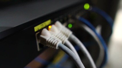 Ethernet switch. Close up. With cables, used and opened ports. Sending and receiving data over the Ethernet in a company