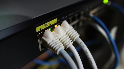 Ethernet switch. Close up. With cables, used and opened ports. Sending and receiving data over the Ethernet in a company