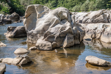 Picture of a big rock standing in a river 