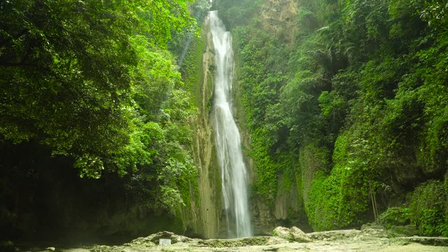 Mantayupan Falls in the jungle, island of Cebu, Philippines. Waterfall in the green forest.