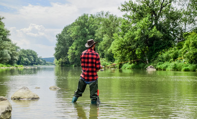 Catch and Release fishing. bearded fisher in water. mature man fly fishing. man catching fish....
