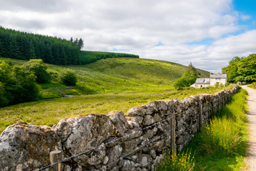 Scenic view of rural cottage and hillside landscape at Dartmoor National Park, Devon, England