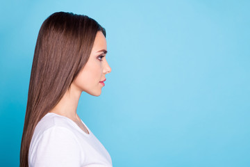 Profile side photo of lovely lady looking wearing white t-shirt isolated over blue background